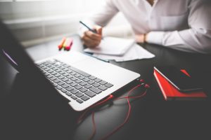 man with notebook and laptop