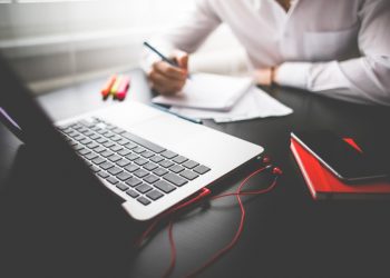 man with notebook and laptop