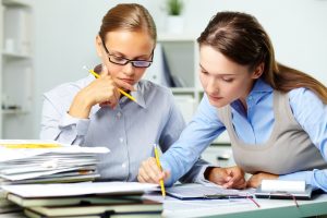 two people reviewing paperwork