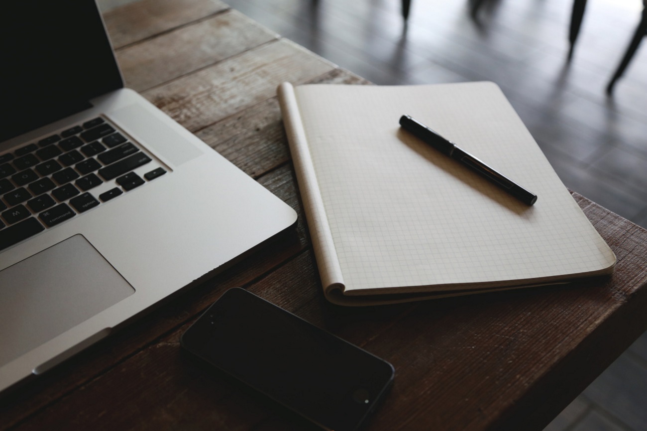 notebook and laptop on table